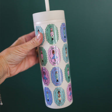 Pippi Post 16 ounce skinny acrylic tumbler featuring colorful Nutcracker ballet scenes with ballerinas and toy soldiers on a white background