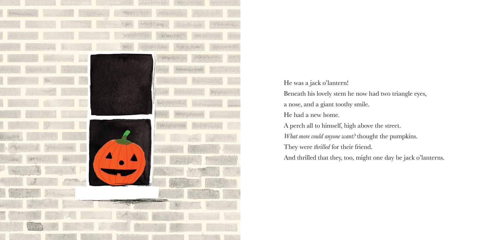 Black towel with orange pumpkin design on a brick wall background