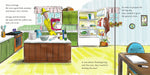 A full-page illustrated book spread showing a cartoon kitchen scene with text boxes around the drawing. A man in a yellow suit stands at a counter, and the room includes green cabinets, a refrigerator, table, chair, and floor.