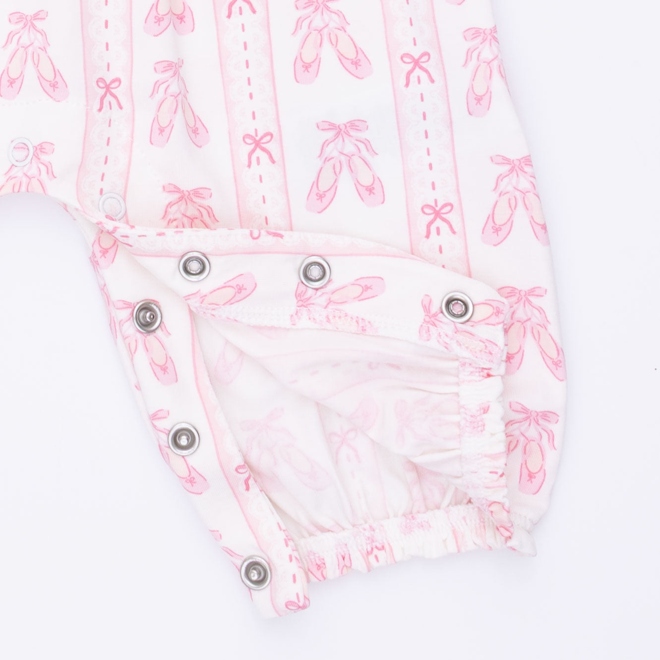Baby romper with pink ballet dancer print on a white background