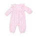 Pink baby onesie with woodland pattern on a white background