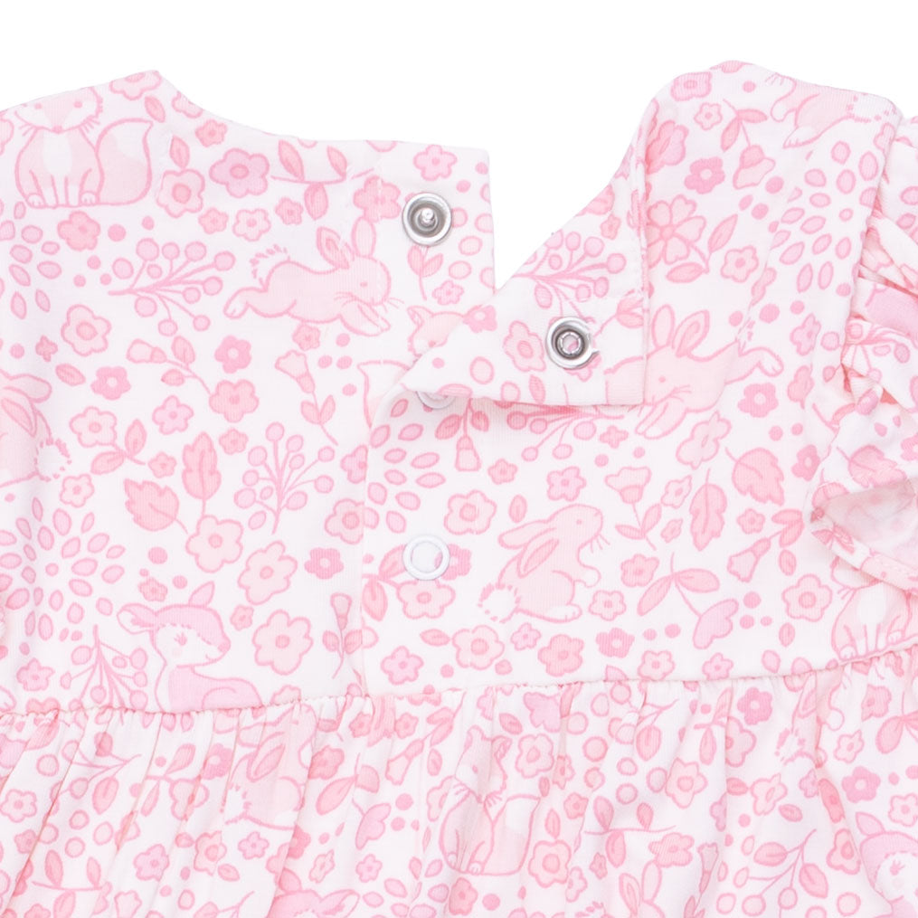 Pink floral and bunny patterned fabric with buttons on a white background