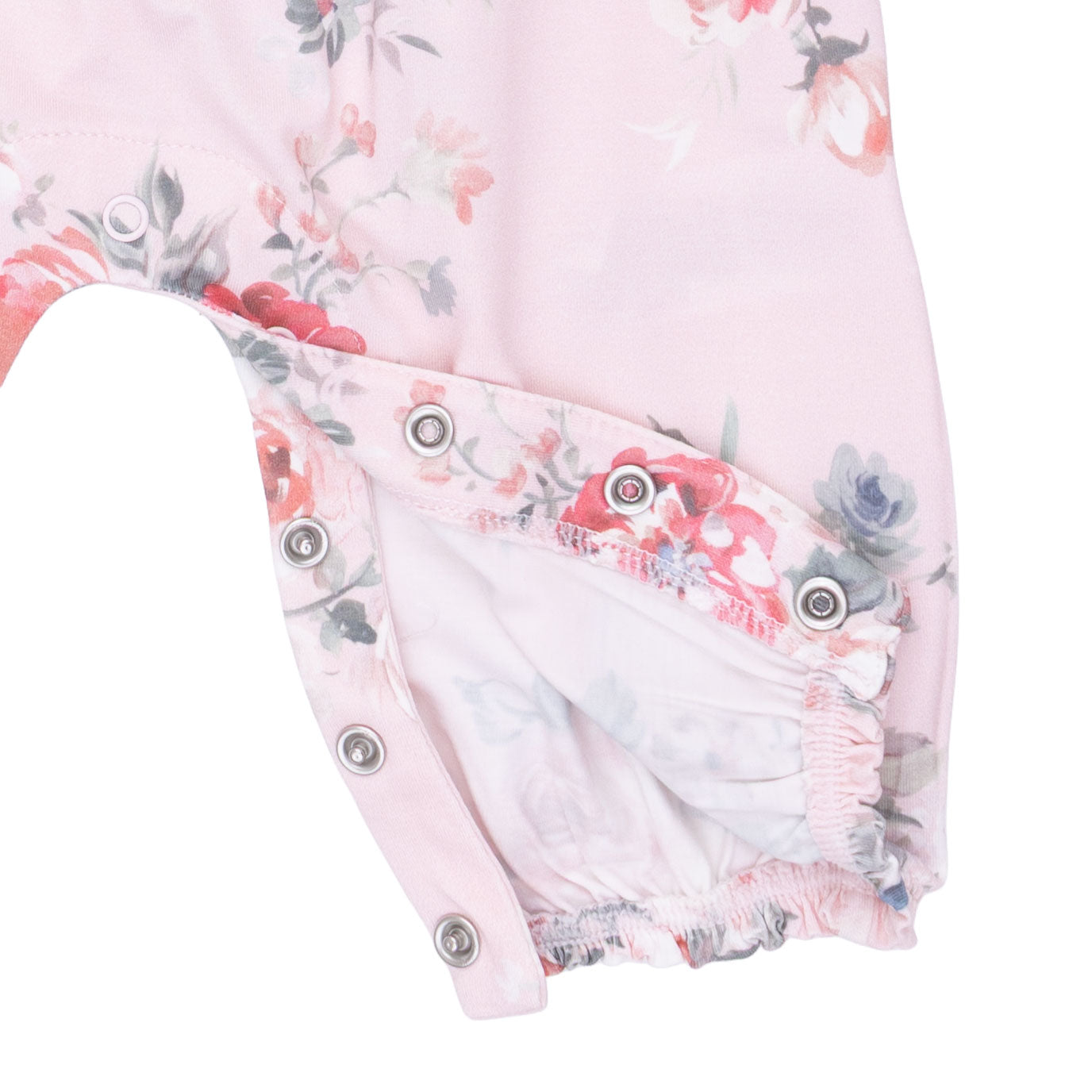 Floral-patterned baby outfit with snaps on a white background