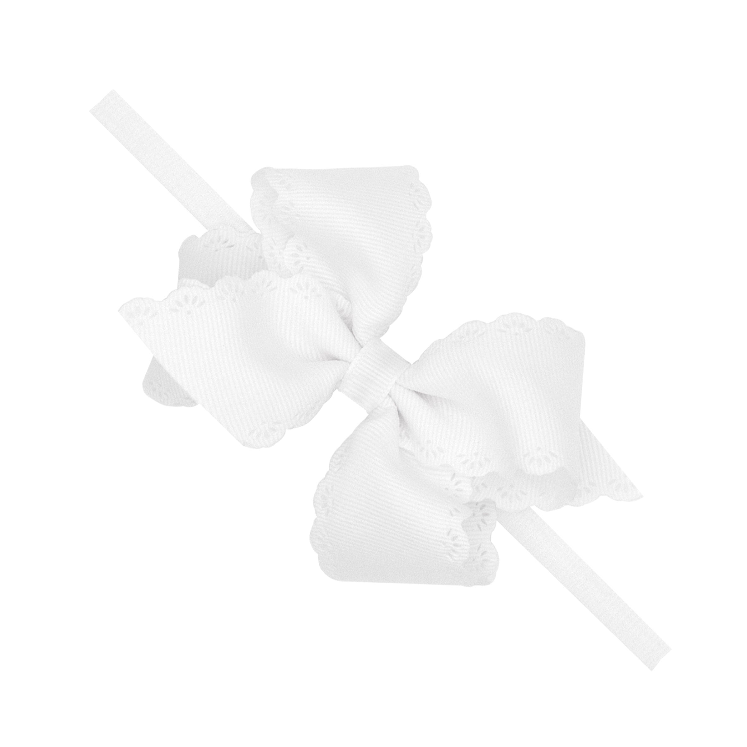 White grosgrain hair bow with embossed eyelet edge on white nylon band