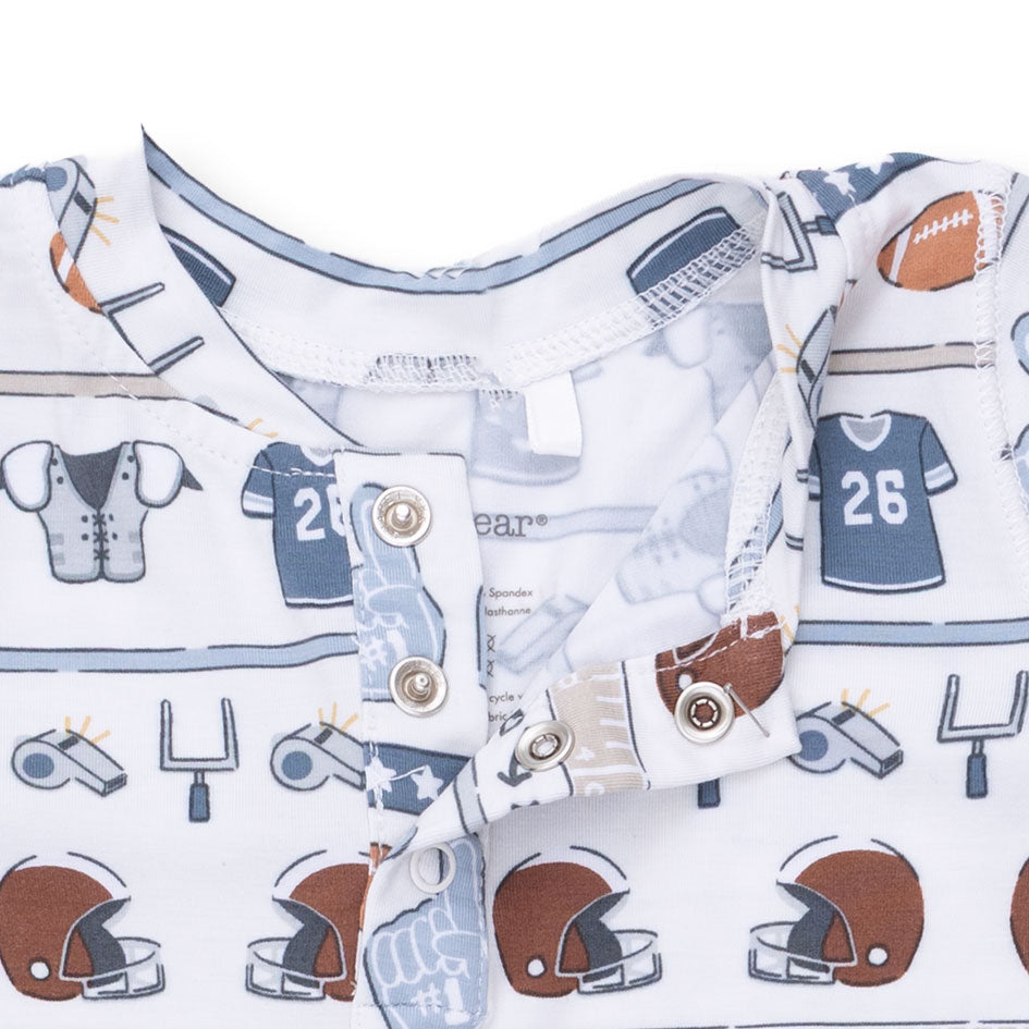 Baby outfit with football-themed print on a white background