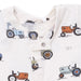 Baby onesie with tractor pattern on a white background