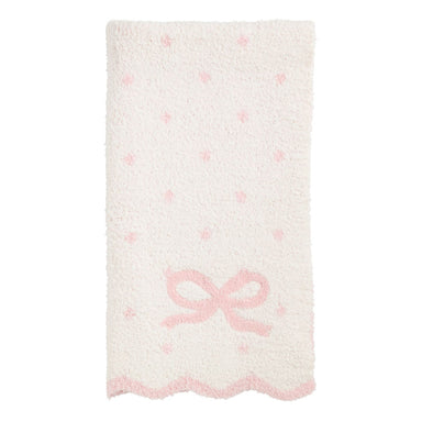 Fluffy blanket with a pink bow and small pink hearts on a white background