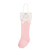 Pink knee-high baby socks with a white label on a white background