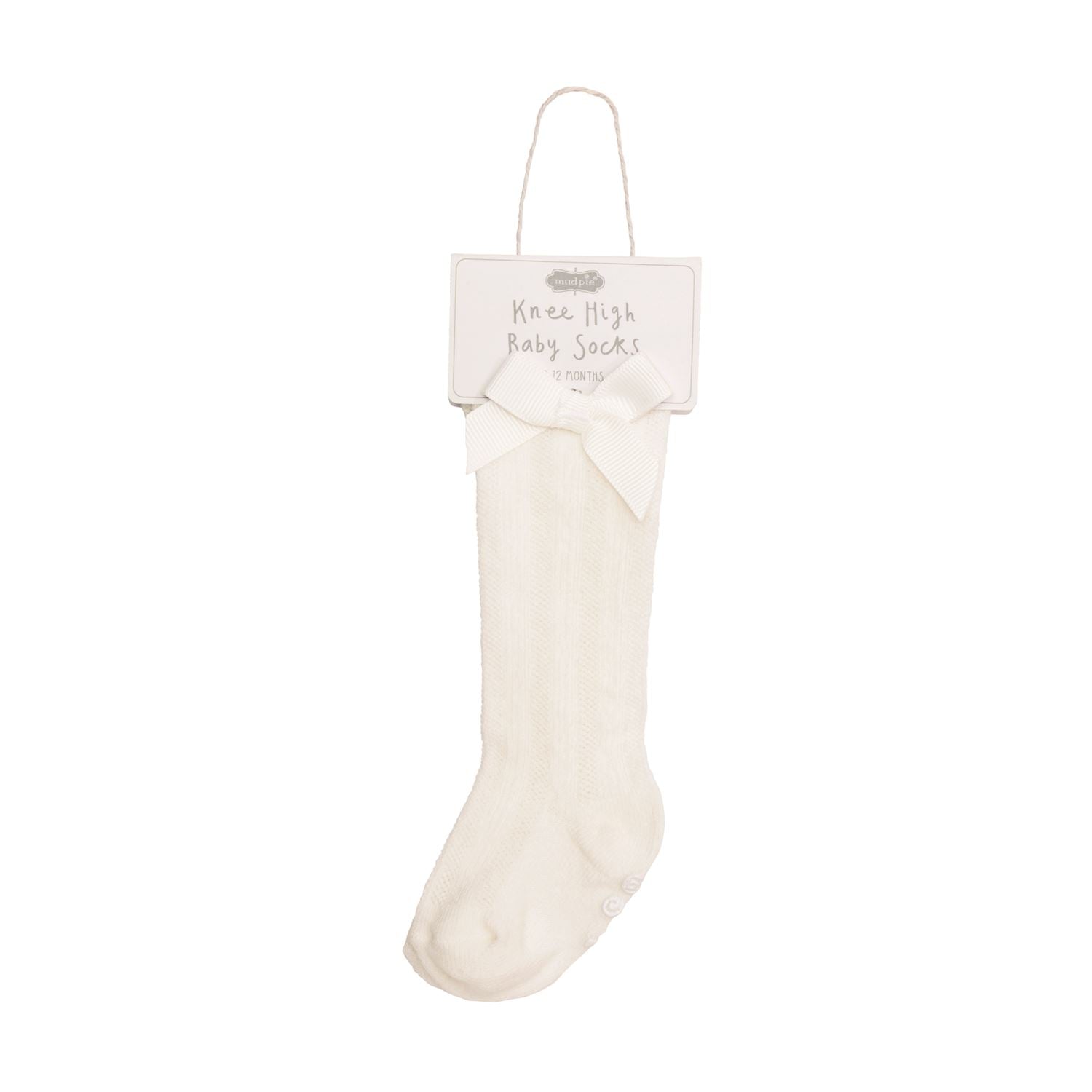 White knee-high baby socks on a white background with a label.