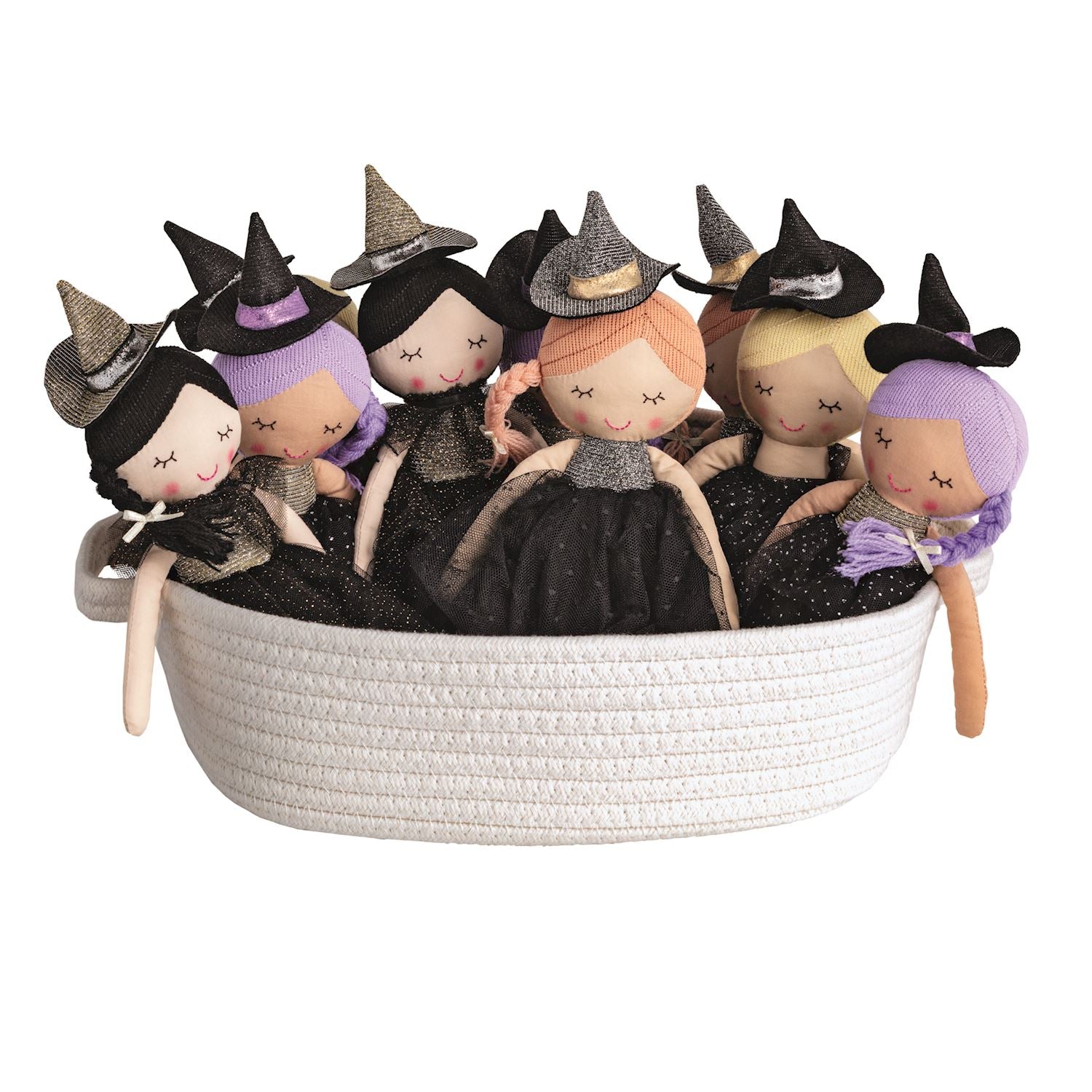 Set of witch-themed dolls with hats in a basket on a white background