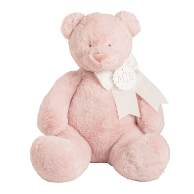 Pink teddy bear with a white bow on a white background