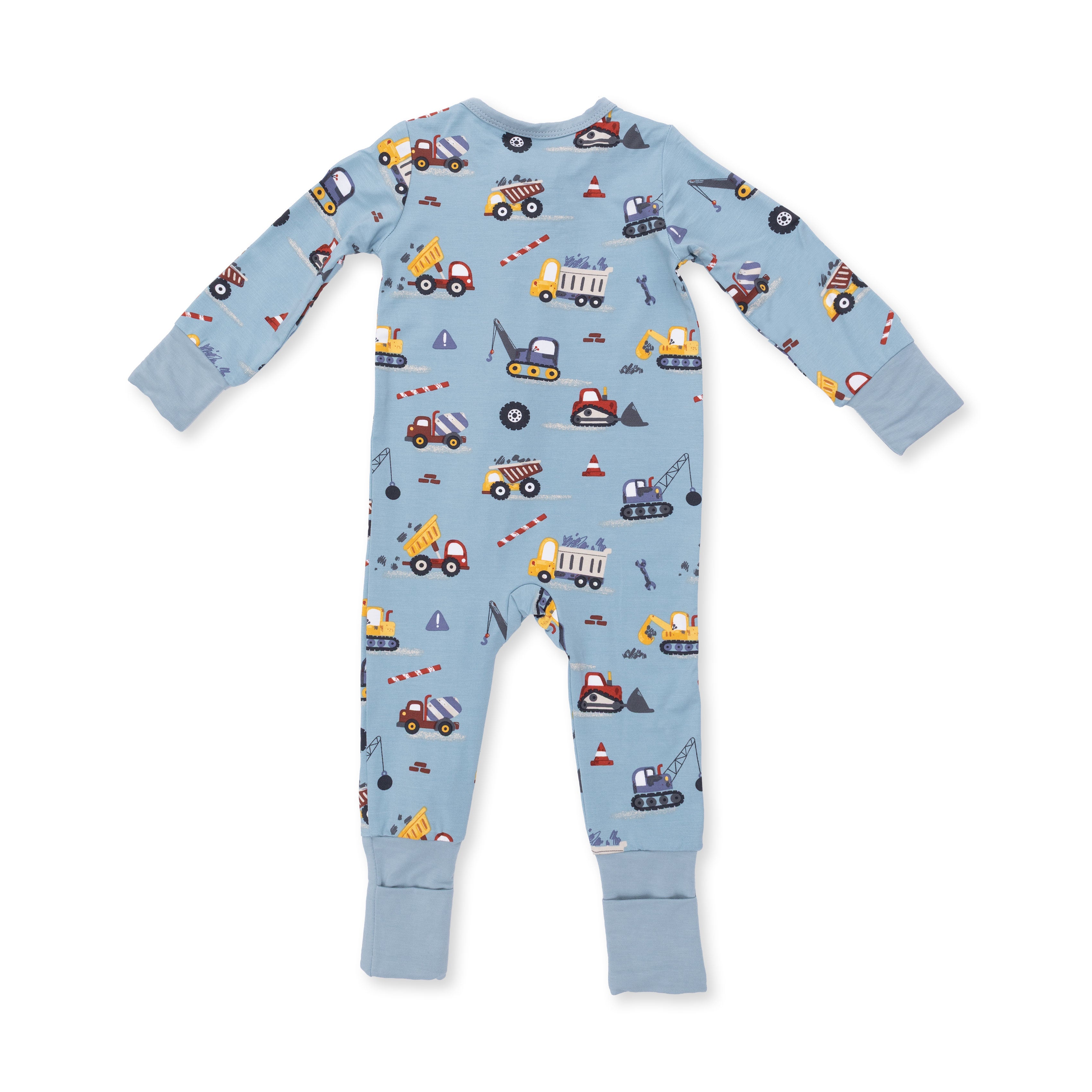 Children's romper with construction vehicle pattern on a light blue background