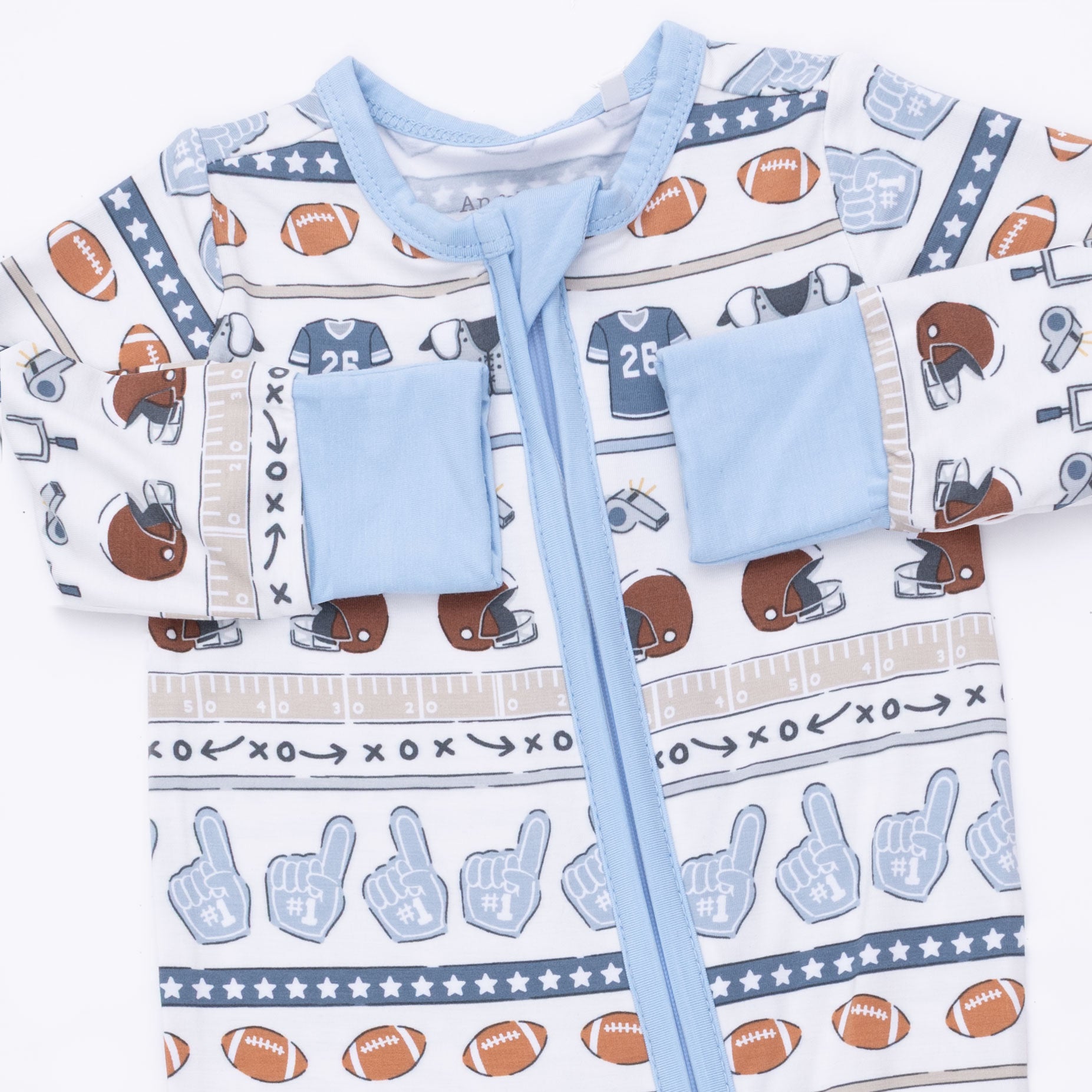 Children's romper with sports-themed pattern on a white background