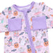 Baby outfit with Halloween-themed design and purple accents on a pink background