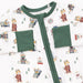 Baby onesie with green trim on a winter sports dogs patterned background
