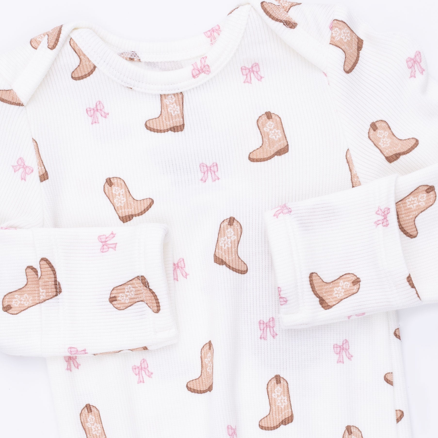 White fabric with pink cowboy boot and star pattern