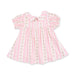 Pink dress with floral patterns on a white background