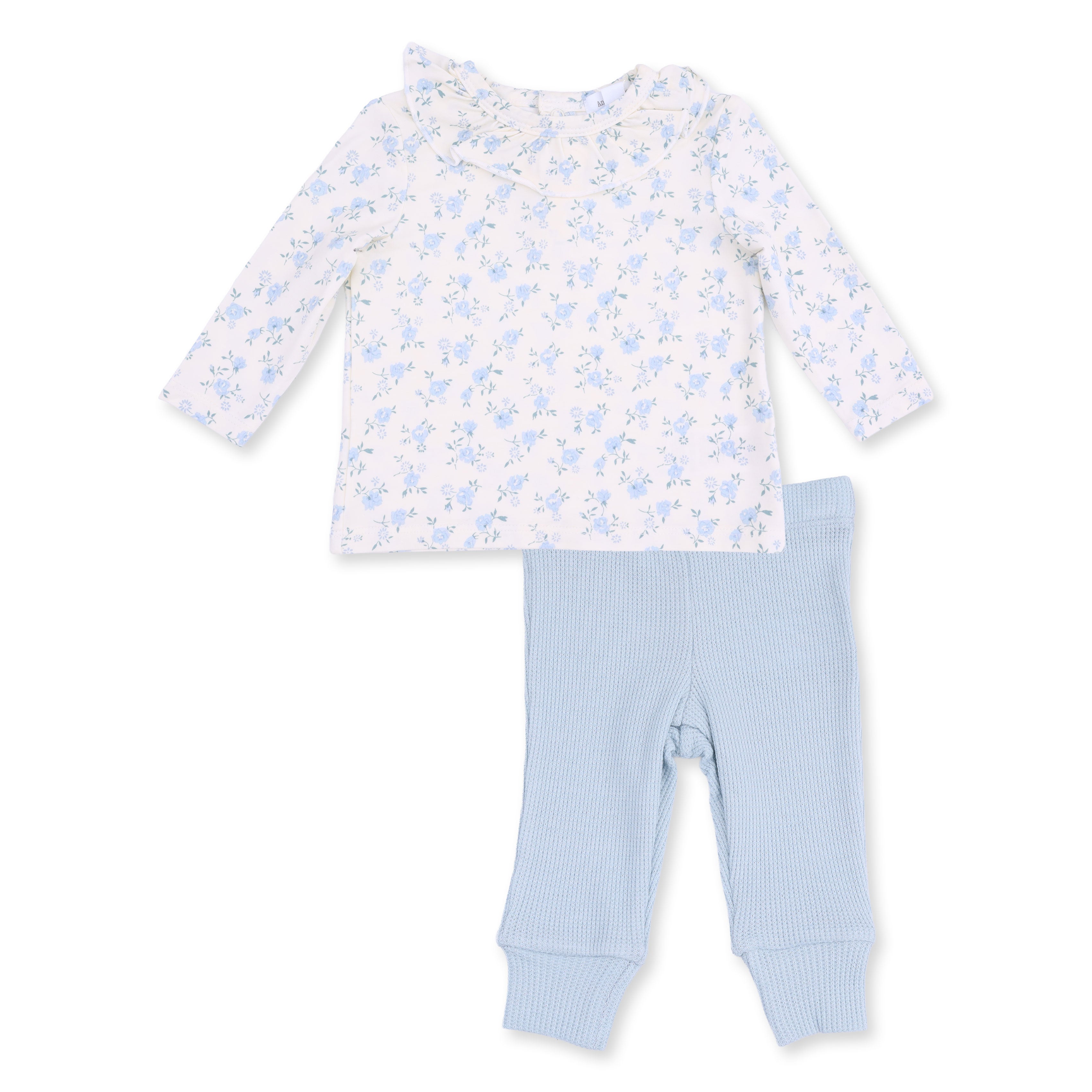 Children's outfit with floral top and light blue pants on a white background