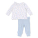 Children's outfit with floral top and light blue pants on a white background