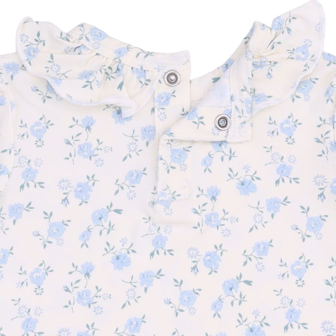 Baby top with blue floral pattern on a white background