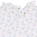 Baby top with blue floral pattern on a white background