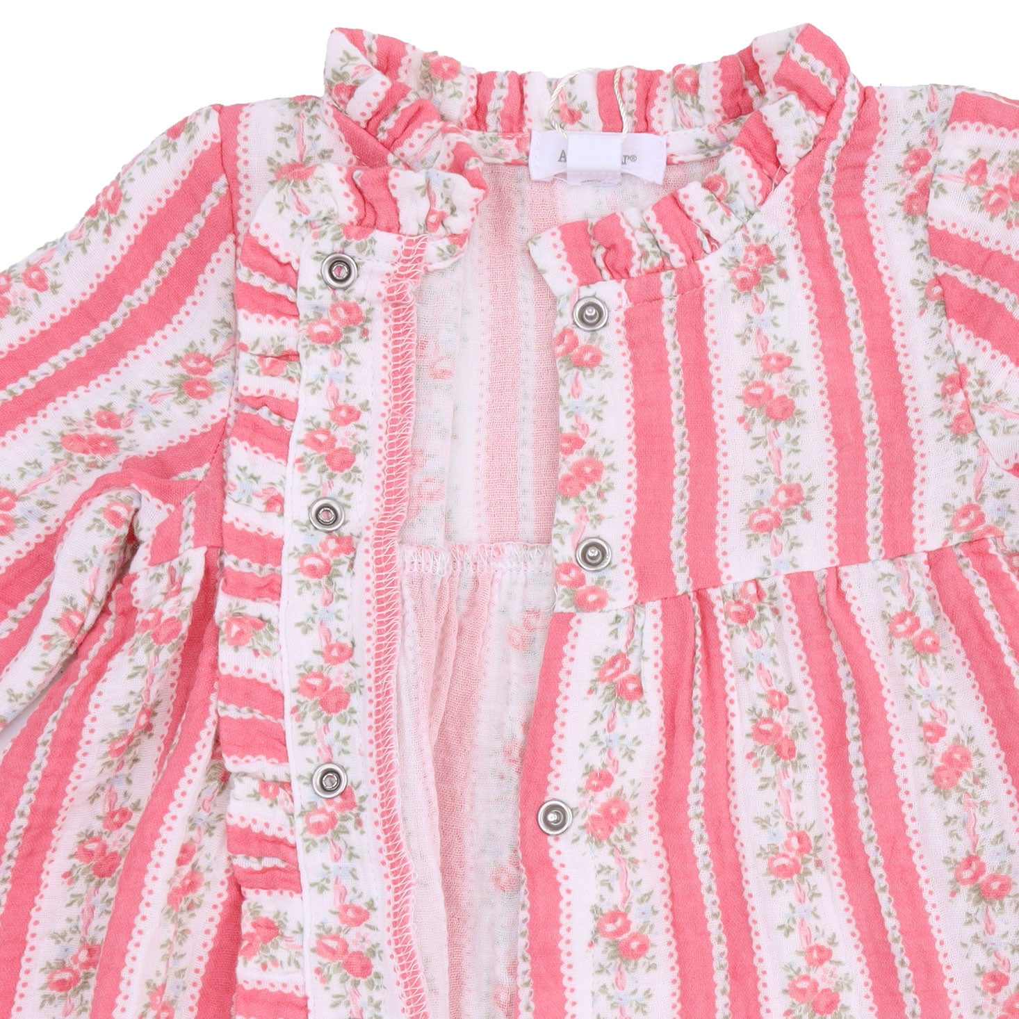 A close-up of a children's long-sleeve blouse with a ruffled collar and button-front closure. The fabric features vertical pink and white stripes with a delicate pink floral print and dotted borders.