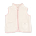 A cream-colored sherpa fleece vest with light pink trim, featuring a front zipper and two heart-shaped pockets on the front.