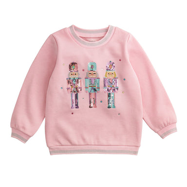Pink sweatshirt with sequin nutcracker design on a white background