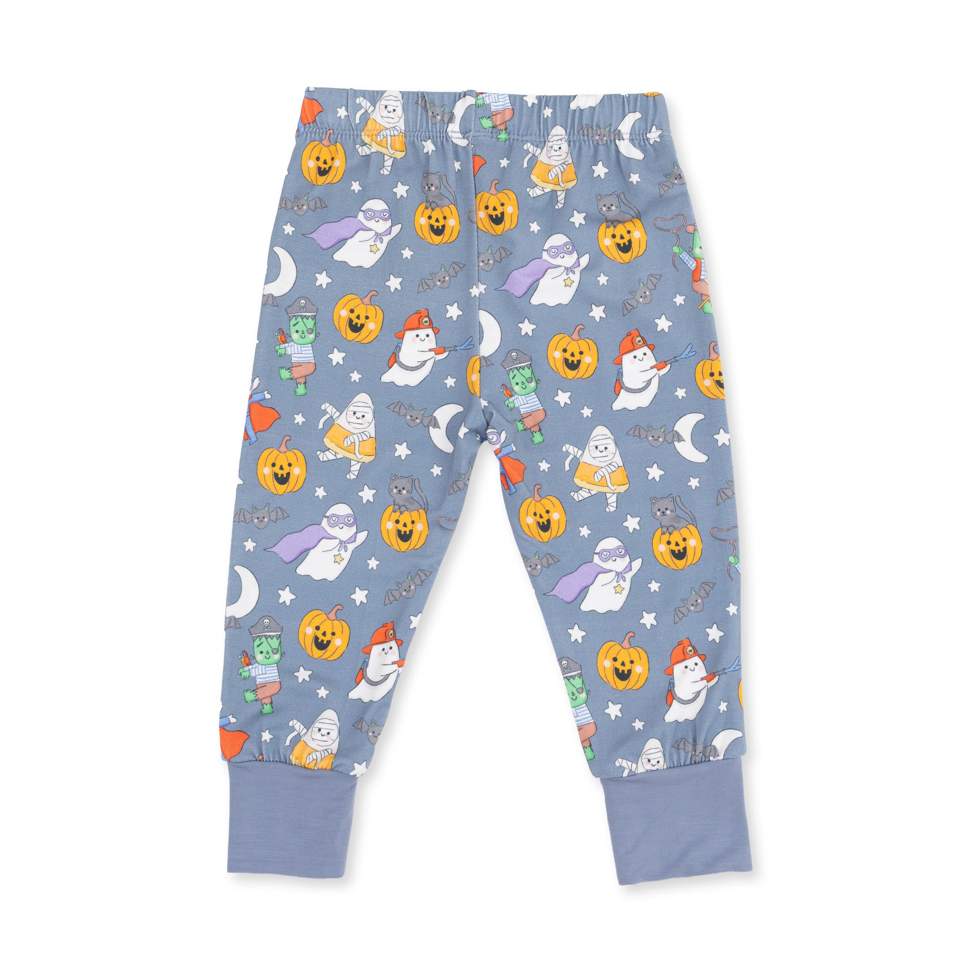 A pair of children's pajama pants in a dusty blue color, featuring an all-over Halloween print with pumpkins, ghosts, cats, and stars. The pants have an elastic waistband and ribbed ankle cuffs.