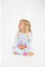girl sitting and wearing blue two piece long sleeve loungewear set with pink fancy cowgirl print
