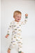 toddler boy wearing off white lounge set with blue, green and tan vintage airplanes print and green on the wrists and ankles