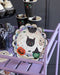 Halloween-themed plate with black cat, ghost, and witch design on a purple stand.