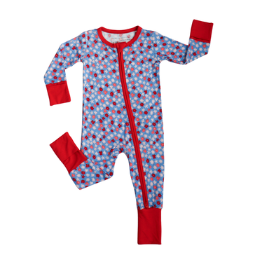 Children's onesie with red and white floral pattern on a blue background