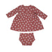 back of dark punch colored long sleeve dress and matching bloomers with white daisy dot print