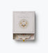 Rifle Paper Co monthly photo cards in an illustrated gift box with metallic silver details and a one month milestone card visible inside