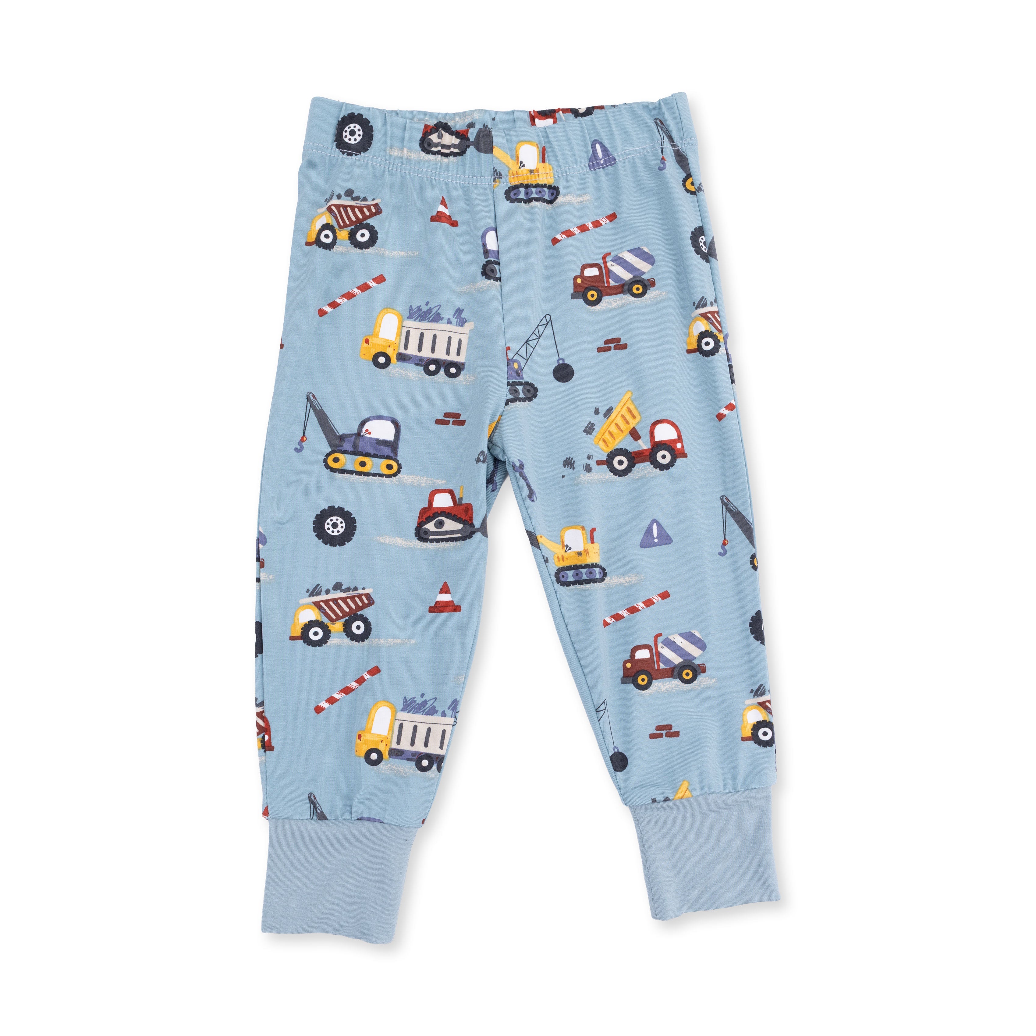 Children's blue pants with construction vehicle pattern on a white background