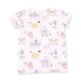 A light pink short-sleeve top with an all-over cartoon print of dogs, bath tubs, brushes, and makeup sponges in pastel purple, yellow, and blue tones, shown flat against a white background.