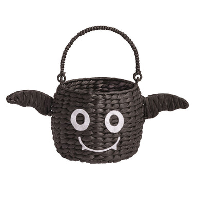 Woven bat basket with a face design on a white background
