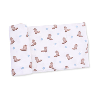 Baby blanket with cowboy boot pattern on a white background