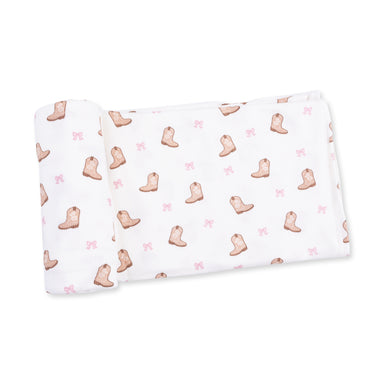 Baby blanket with cowboy boot and pink bow pattern on a white background