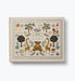 Embroidered baby book cover with giraffes bears swan trees and floral details in a vintage storybook design by Rifle Paper Co.