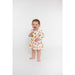toddler girl wearing white skirted bodysuit with pumpkin spice donuts and coffee print