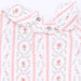 Close-up of a baby outfit featuring a white base with vertical pink stripes and a delicate pink, green, and lavender floral print.