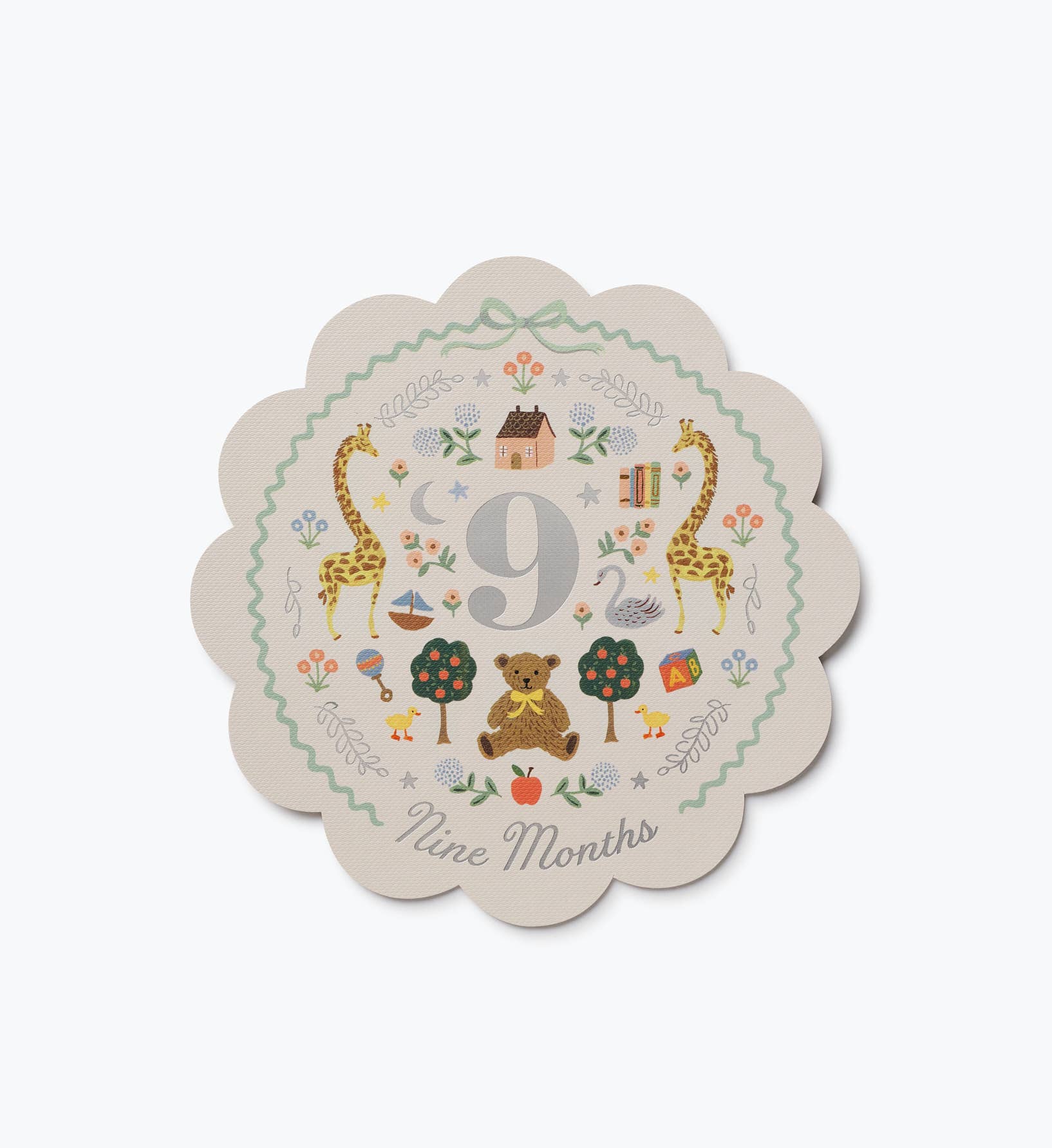 Illustrated nine month milestone card from Rifle Paper Co with scalloped edges colorful animals flowers trees and a large number nine design