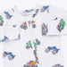Children's pajamas with monster truck designs on a white background