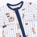 A close-up of a baby long-sleeve pajama top featuring a white base with thin navy blue pinstripes, a solid navy collar and front tie closure, and an all-over print of teddy bears in baseball and sports outfits.