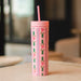 Pink Pippi Post 16 ounce acrylic tumbler with straw featuring festive holly leaves red berries and scalloped stripe patterns on a cheerful holiday design