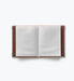 Open small photo album with blank slip in pages and patterned cover edges by Rifle Paper Co.
