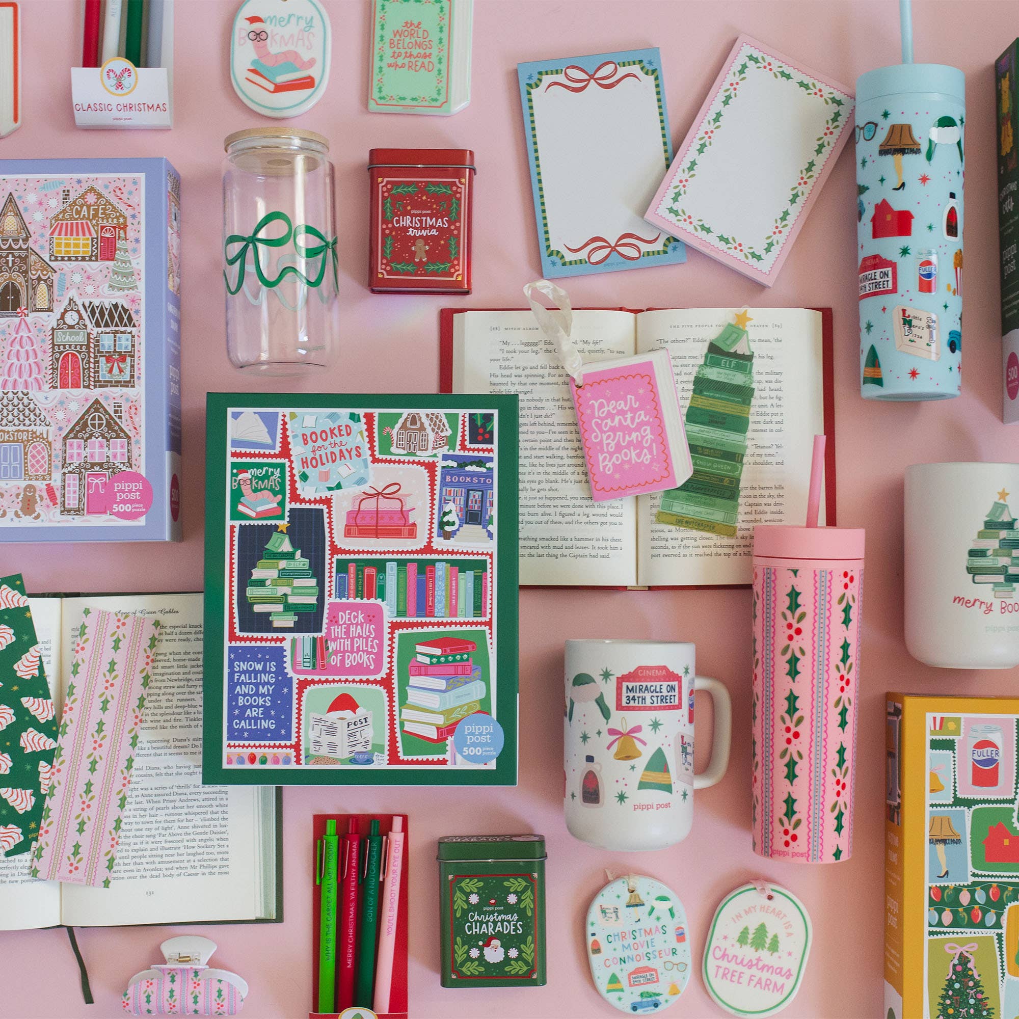Pippi Post Gingerbread Square Christmas jigsaw puzzle box featuring a colorful gingerbread village scene surrounded by festive holiday stationery and gifts on a pink background