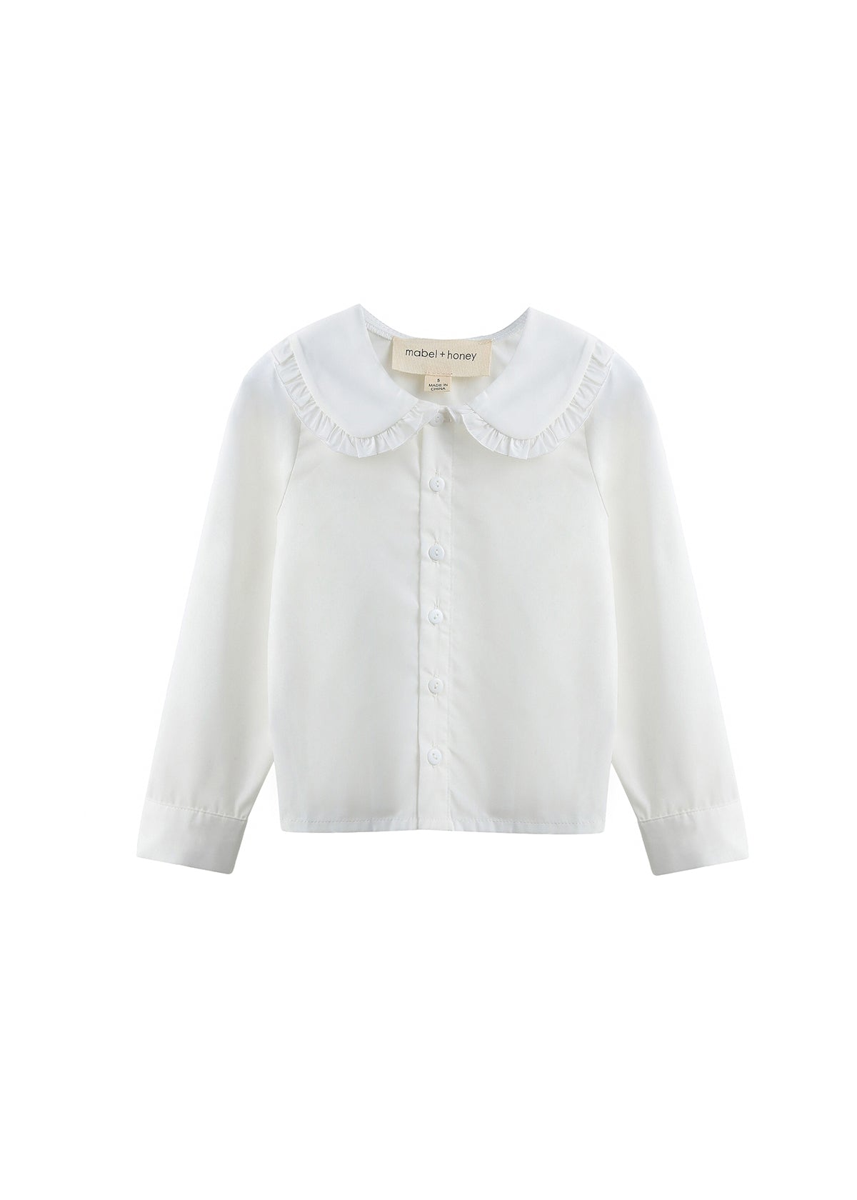 A white long-sleeve button-up blouse for children, featuring a wide ruffled Peter Pan collar and a small brand label at the inner neck, displayed on a clean white background.